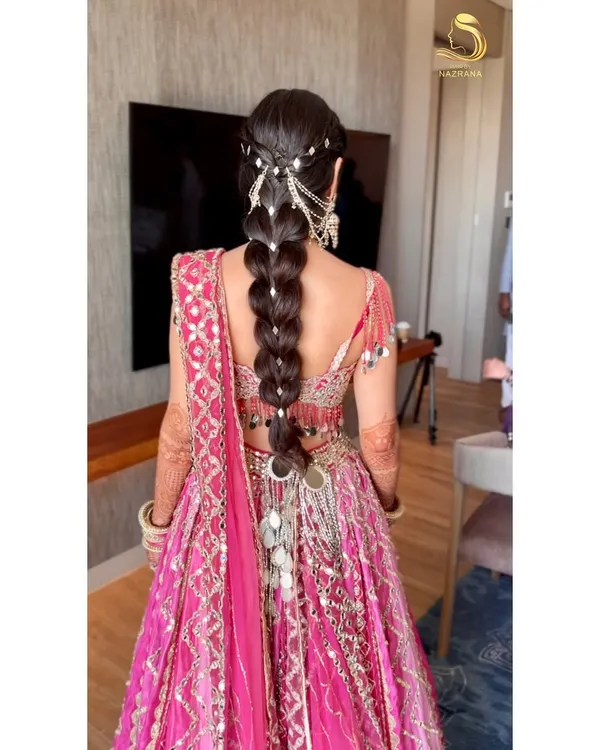 This is the kind of magic I love to create. For my bride's Mehendi in Thailand, we designed this intricate mirror-work braid to catch the light and match the sparkle of her Abhinav Mishra outfit. It’s all about the details!