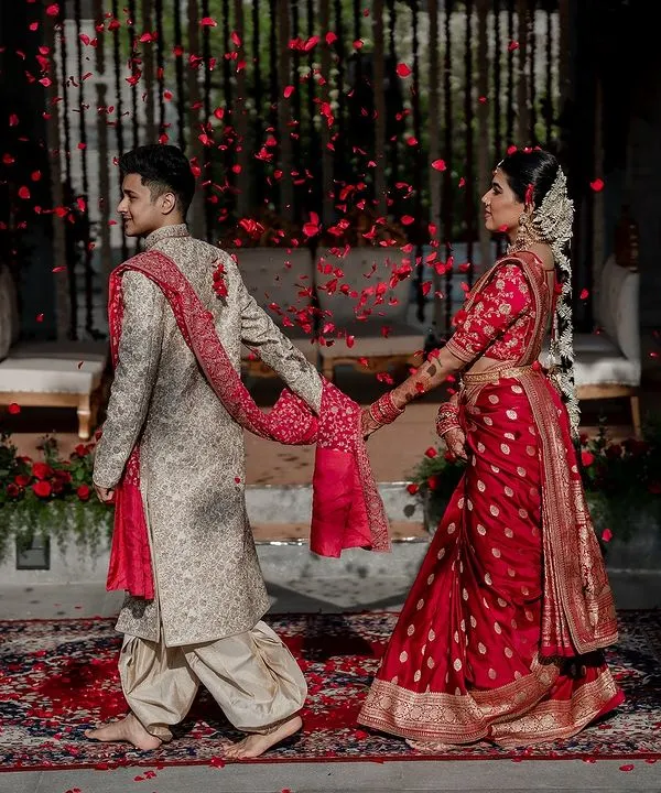 We live for moments like these. A grand exit under a shower of petals for Laksha and Partha, perfectly capturing the magic of their Sabyasachi and Tarun Tahiliani ensembles at the breathtaking Amitarasa venue.