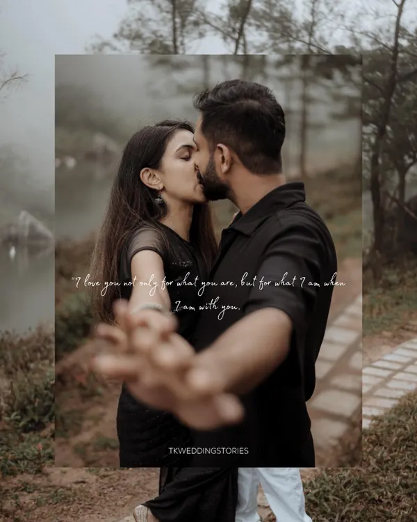 A romantic pre-wedding moment captured in the moody, atmospheric landscape of Vagamon. The couple shares a kiss, framed by nature, creating a timeless and cinematic save-the-date photo.