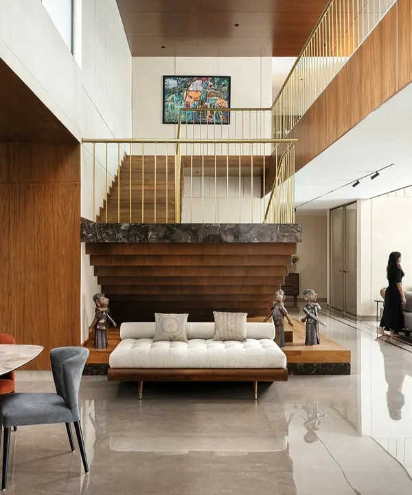 This double-height living space in our Villa Shakthi project is designed as the heart of the home. The sculptural staircase, crafted from marble, wood, and steel, acts as a central connecting element, demonstrating our approach to creating dramatic spatial narratives and using materials to define a home's character.