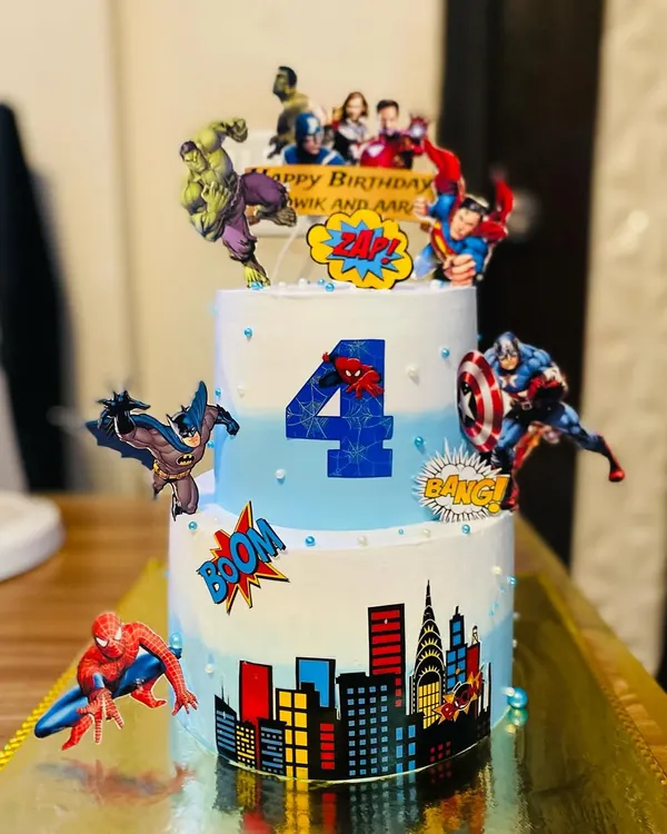 A dynamic two-tier Avengers cake featuring The Hulk, Captain America, and Spider-Man.