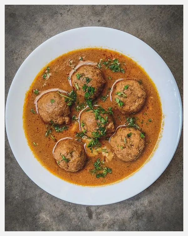 This is my Khaima Unde Saaru, the epitome of Old Bangalore Naati cuisine. I make these flavourful meatballs with hand-minced Bannur lamb and a secret blend of family spices, served in a rich, marrow-infused gravy. It's a recipe that has been in my family for over 150 years.