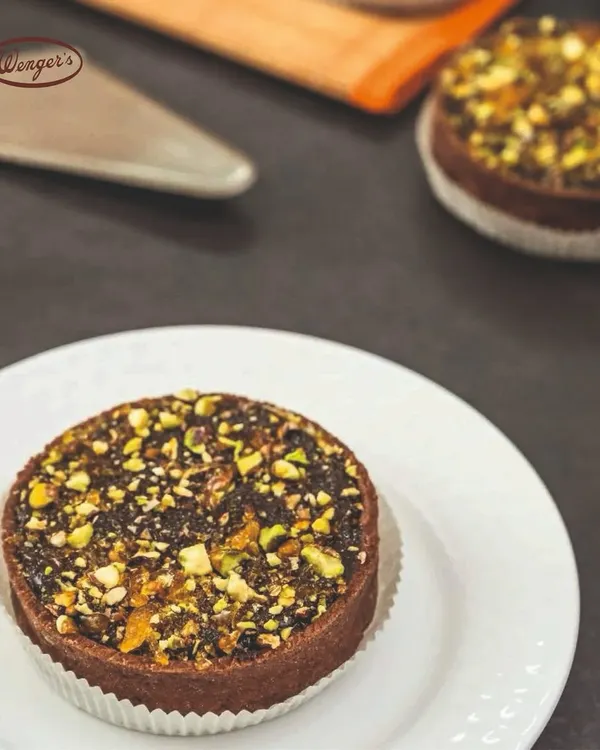 Our chocolate pistachio tart is a rich and nutty delight. The chocolate tart shell is filled with a decadent chocolate filling and generously topped with chopped pistachios.