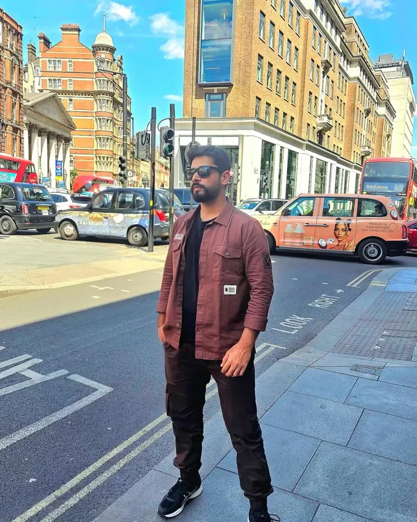 A full-length shot on a street in London's financial district. This demonstrates a confident, modern look suitable for urban fashion, travel, or lifestyle brand campaigns.