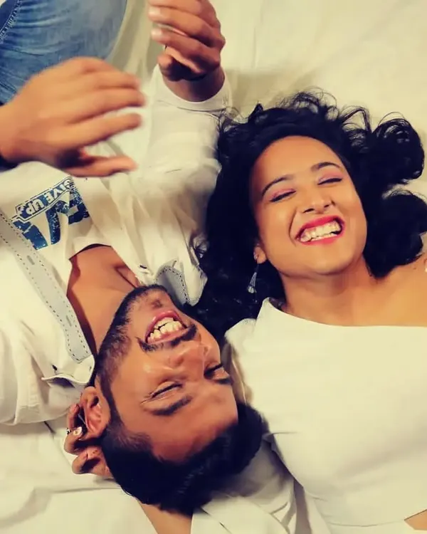 A pure, candid moment of a couple laughing together, captured from a unique overhead angle.