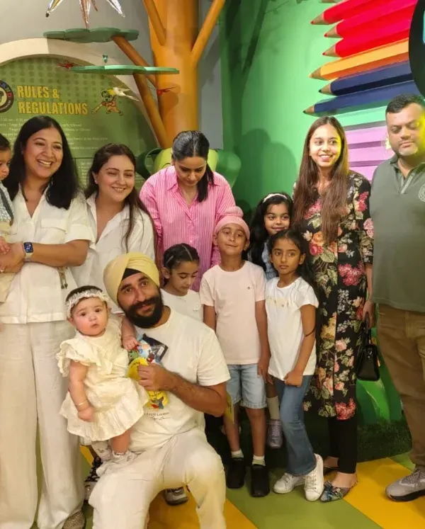 A large family group with multiple kids and adults poses for a photo. We can easily accommodate multi-generational gatherings for a day of fun.