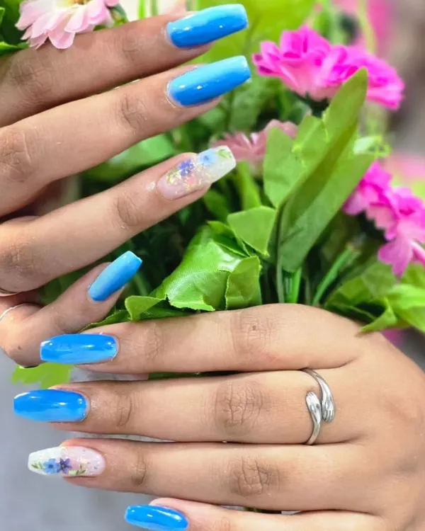 Beautiful blue ombre nails with a delicate floral accent, created by my student Pallavi. This showcases her skill in both blending colors and freehand painting.