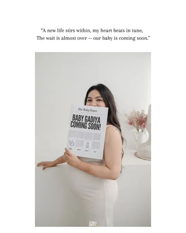 A creative and sweet announcement. This mother-to-be holds a custom "Baby Times" newspaper, sharing her exciting news with a beautiful smile in a bright, minimalist setting.