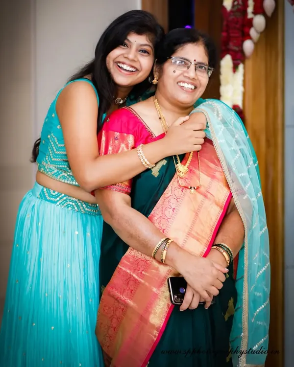 A candid moment of pure joy and laughter between a mother and daughter at a family event. We look for these authentic interactions that make the best memories.