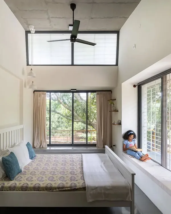 A quiet moment in a sunlit bedroom at our Aamra residence. We design spaces that invite tranquility and connection, where natural light and views of the outdoors become integral parts of daily life. This window seat is more than a feature; it is a personal retreat.