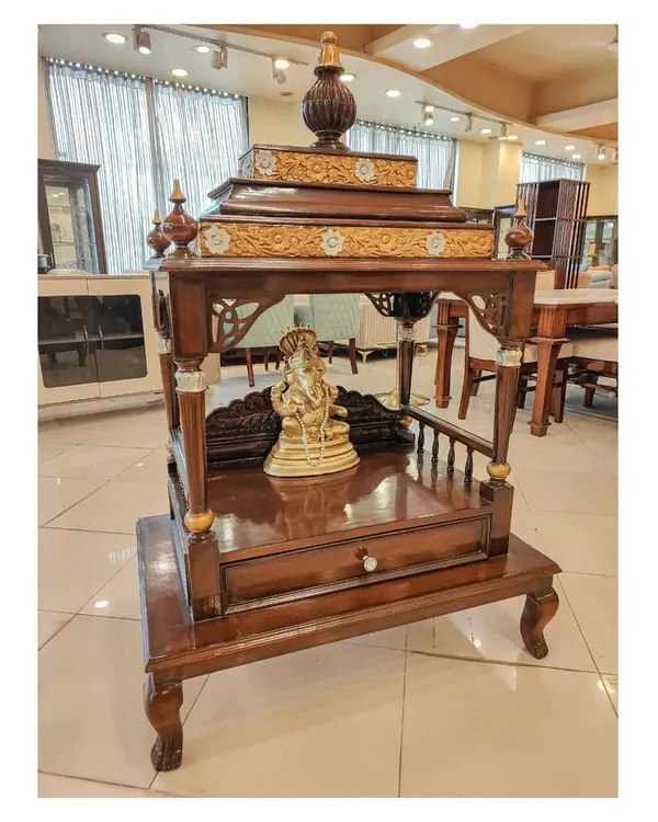 Another view of the solid teak wood pooja mandir, showing the rich grain of the wood and the detailed craftsmanship from a different angle. The design includes a drawer for storing pooja essentials.