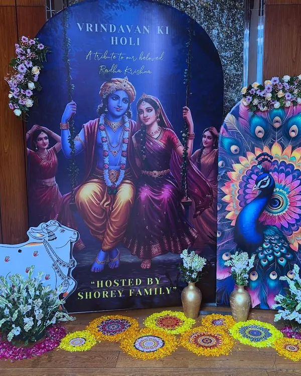 A beautiful 'Vrindavan ki Holi' setup for the Shorey family. The decor featured a large backdrop of Radha and Krishna, a peacock panel, and a cow cutout, creating a divine atmosphere.