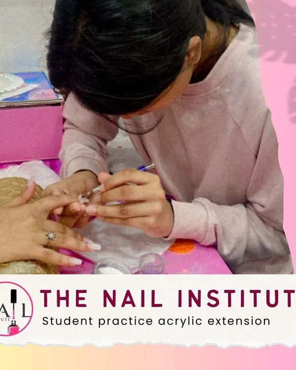 Practice makes perfect. A student carefully applies acrylic, building the structure for a durable and elegant nail extension.