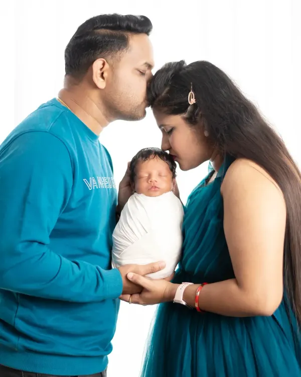 The first family photo. This image captures the tender moment when new parents hold their baby together, marking the beautiful beginning of their journey as a family.