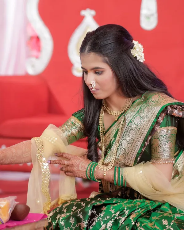 My engagement bride Karishma during her ceremony. The makeup is soft and traditional, complementing her green saree.