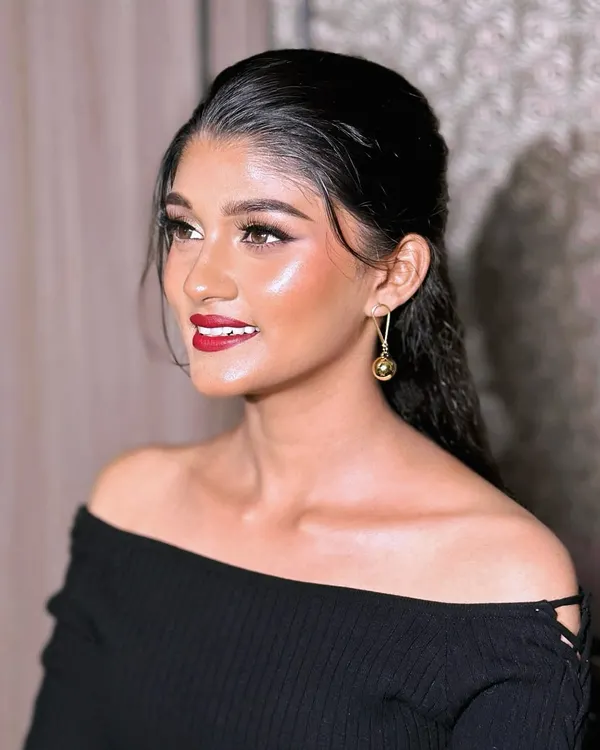 This is the epitome of modern glam. A sleek, wet-look hairstyle paired with luminous 'glass skin' and a classic red lip. This look is perfect for a cocktail party or a chic reception.