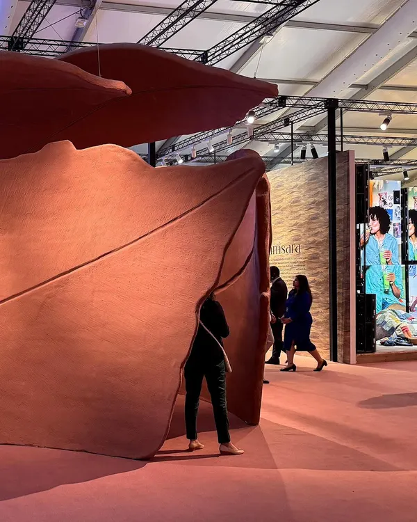 A visitor finds a moment of quiet contemplation within the sweeping curves of our 'Terra' installation. The piece is a visual poem about leaves, rendered in abstract forms to capture the feeling of shedding and returning to the earth.