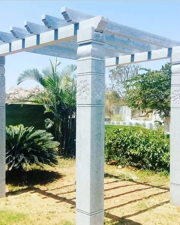 A beautiful Sadahalli stone pergola installed in a garden. I carve these with custom details like the floral motifs on the pillars.