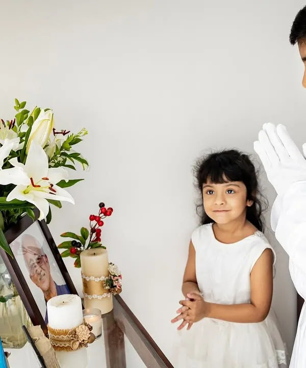 It was an honor to document Rehaan's Holy Communion. Here, he and his sister share a quiet moment by a memorial for a loved one, a poignant part of their family's story on this important day.