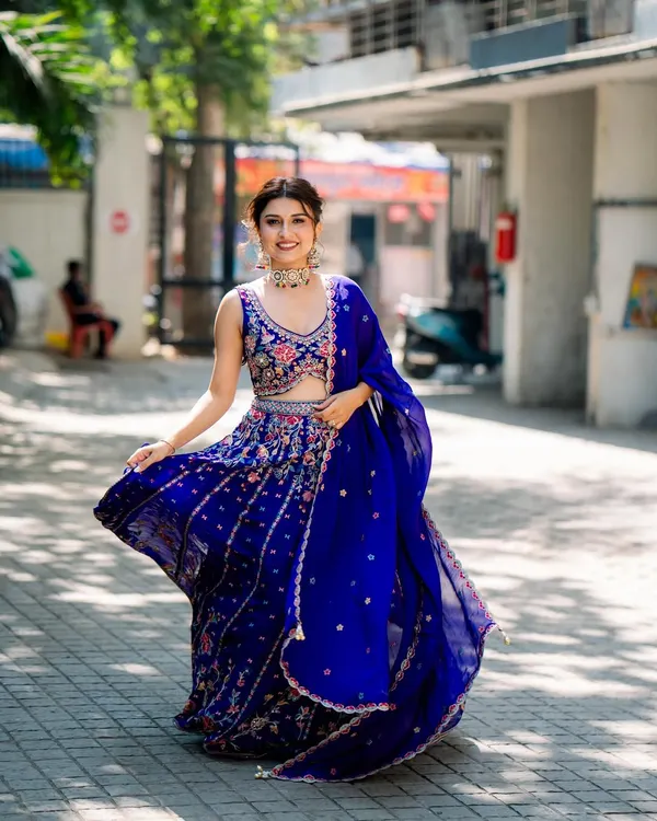 Another shot of our beautiful client twirling in the royal blue floral lehenga. Her smile says it all. It’s about feeling joyful and confident on your special day.