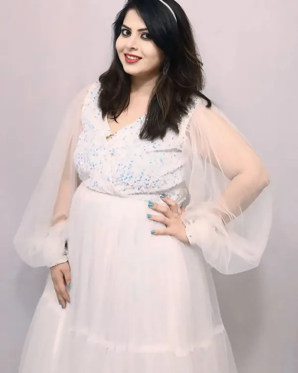 A beautiful portrait in my white sequin flare gown. It features a sparkling bodice and delicate sheer balloon sleeves for a touch of whimsical elegance.