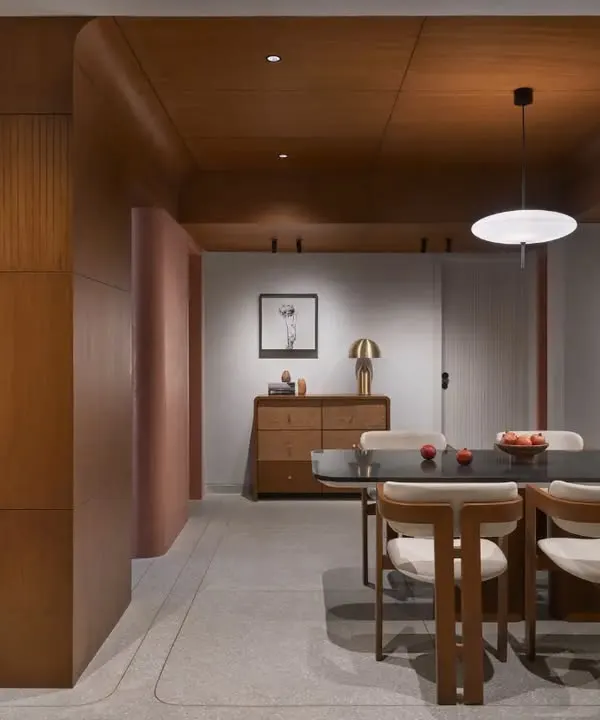 This open-plan living and dining area captures my signature Japandi style, blending warm wood tones on the ceiling with cool terrazzo flooring. The design creates a seamless flow, making it the true heart of the home.
