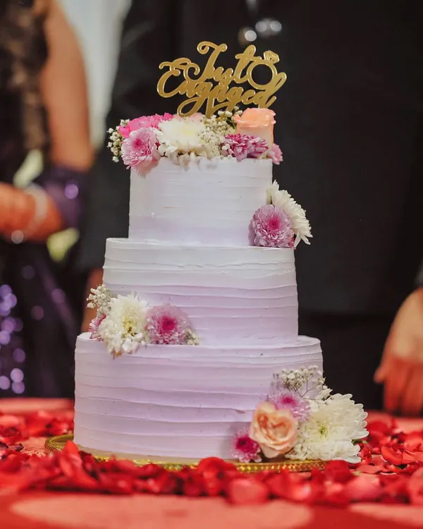 This three-tiered lavender beauty was the star of an engagement ceremony. It's a 6kg Chocolate Truffle cake, made with rich couverture chocolate, and decorated with fresh, delicate flowers for an elegant touch.