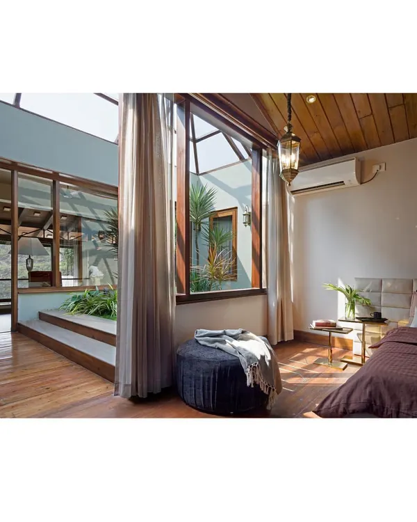 This master bedroom from my 'Aangan' project embodies my design philosophy. It opens up to an internal courtyard, blurring the lines between indoors and outdoors and creating a private sanctuary filled with natural light and greenery. This is biophilic design in practice, a home that breathes with you.
