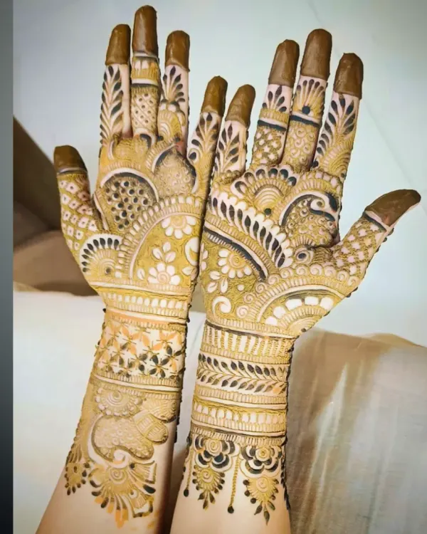 A beautiful, dense party mehandi design with a mix of floral and traditional patterns, covering the full palm.