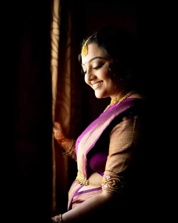 An artistic bridal portrait using shadows and light to create a sense of mystery and elegance as she gets ready.