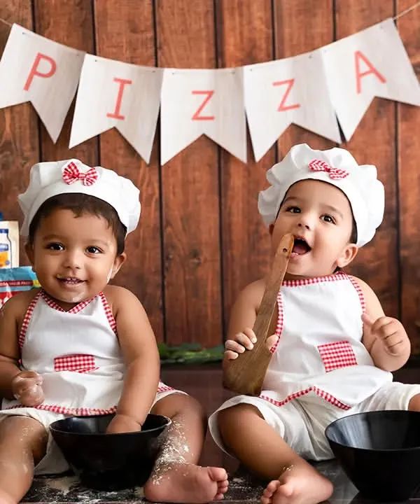 A creative and fun 'Little Chefs' themed photoshoot for one-year-old twins. I provide all the props and setup for unique milestone sessions in my studio.