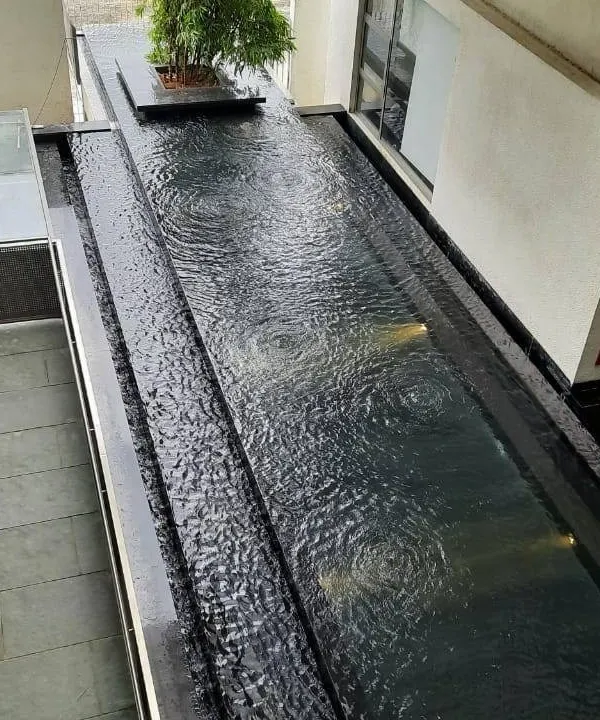 A water body at the VIT School of Architecture, which acts as a passive cooling element. The positioning of water features and wind tunnels helps to naturally regulate the building's temperature.