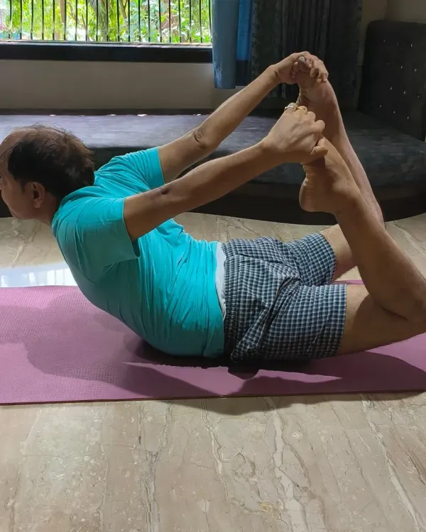 A client demonstrating Dhanurasana (Bow Pose), an excellent asana for strengthening the back and improving posture.