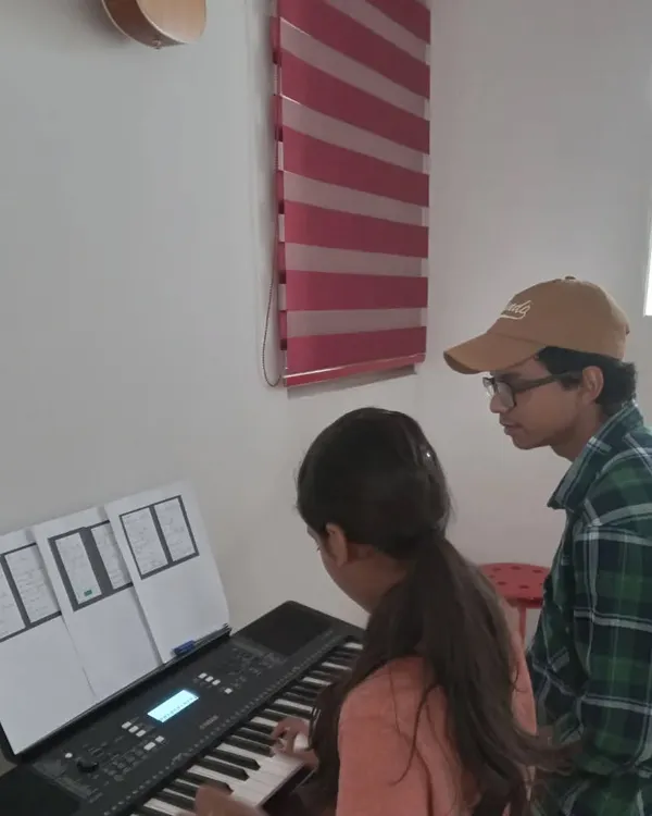A student receives personalized guidance from her keyboard instructor. This individual attention is key to our teaching philosophy.