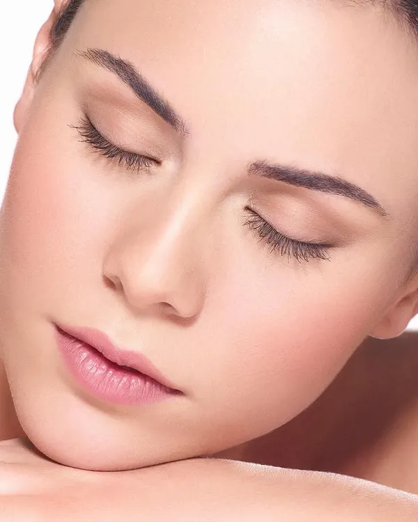 A classic, clean beauty shot with a focus on serene expression and flawless skin. The soft lighting and minimal styling make it perfect for showcasing natural beauty or skincare products.