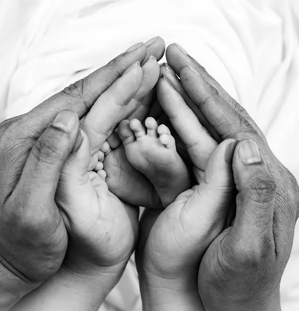I believe the smallest details hold the biggest love. This close-up of a newborn's tiny feet held safely in their parent's hands is a powerful symbol of new life and the unbreakable family bond.