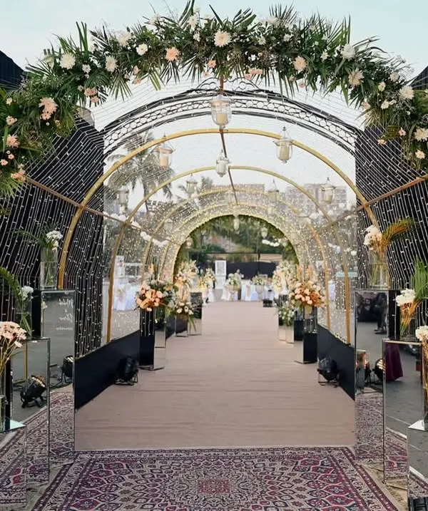 I designed this stunning entrance tunnel with cascading floral arches and a canopy of fairy lights. It creates a truly magical experience, making guests feel like they are walking through an enchanted garden on their way to the celebration.