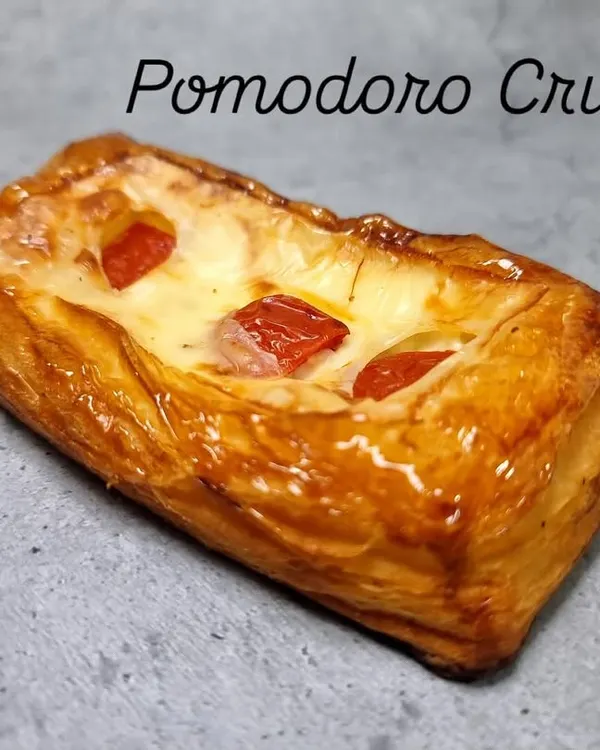 Our Pomodoro and Cheese Croissant, part of our new range. It's a savory delight, with tangy tomato and melted cheese baked into our flaky, buttery pastry.