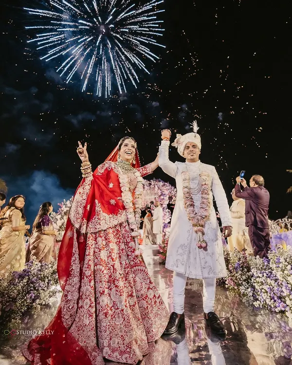 Pure joy as the couple jumps for a photo under a sky full of fireworks at their Thailand beach wedding. This shot perfectly captures the celebratory spirit of a destination wedding.