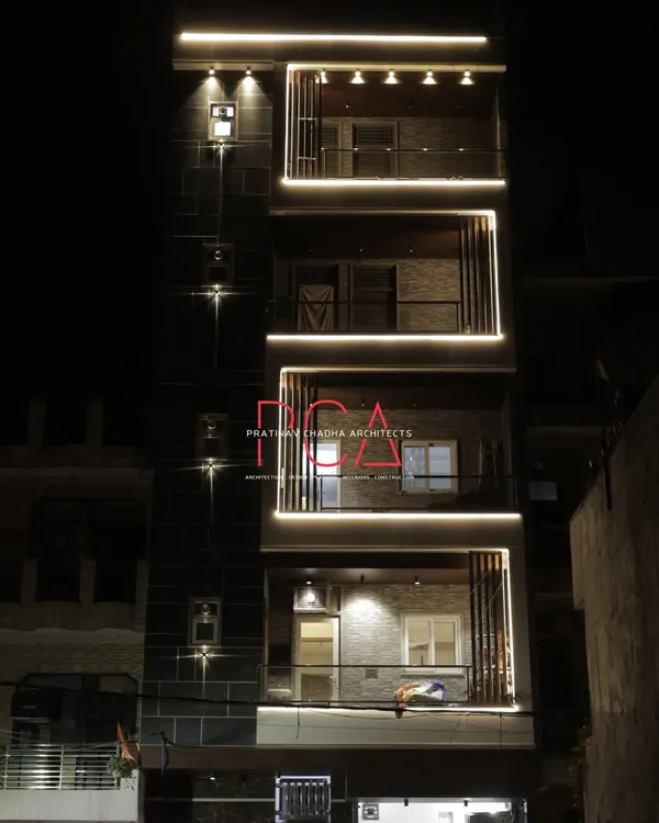This is the completed facade of The Cursive Abode in New Delhi, illuminated at night. The strategic use of profile lighting highlights the clean lines and modern form of the residence, creating a dramatic and luxurious statement that exemplifies my approach to contemporary residential architecture.