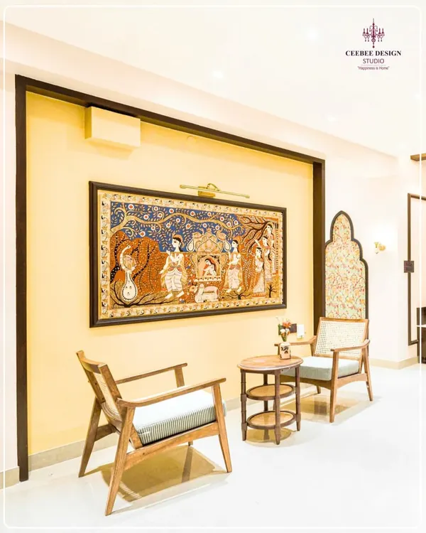 A seating nook featuring a large, framed Pattachitra painting, showcasing the celebration of India's living heritage.
