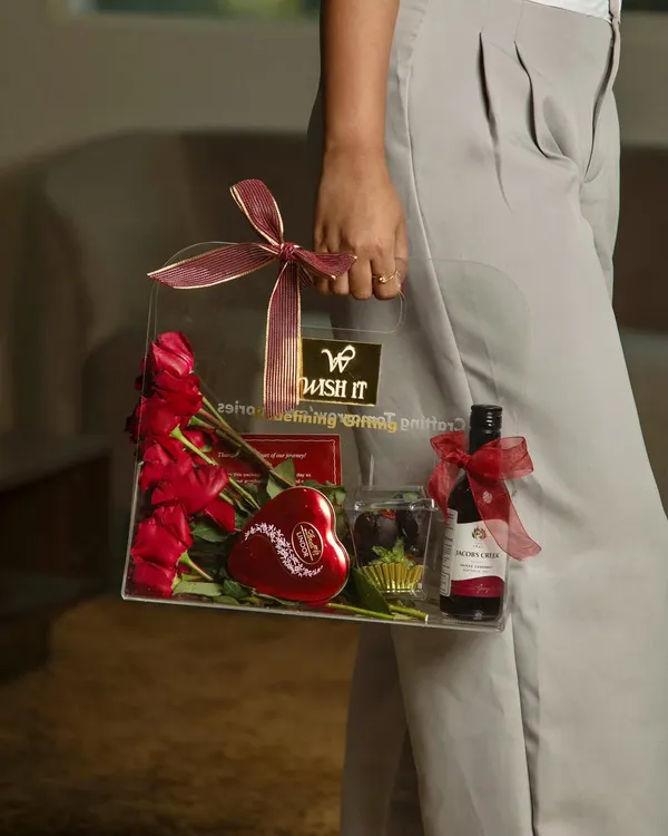 This is our "The Love Affair" acrylic gift bag, a unique and elegant way to show someone you care. It’s perfect for Valentine's Day, anniversaries, or any romantic occasion, filled with beautiful roses, wine, and chocolates.