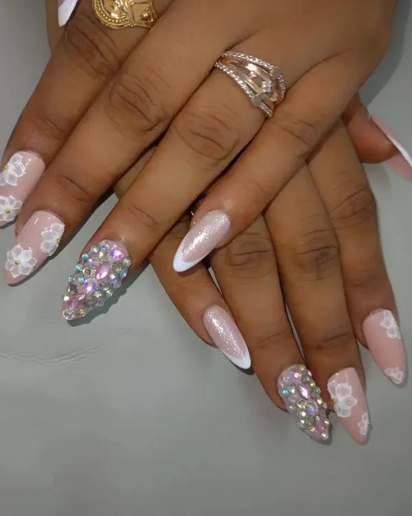 A beautiful bridal set combining soft pink gel, 3D acrylic flowers, and a full accent nail covered in sparkling Swarovski crystals. This design is perfect for adding a touch of glamour to your wedding look.