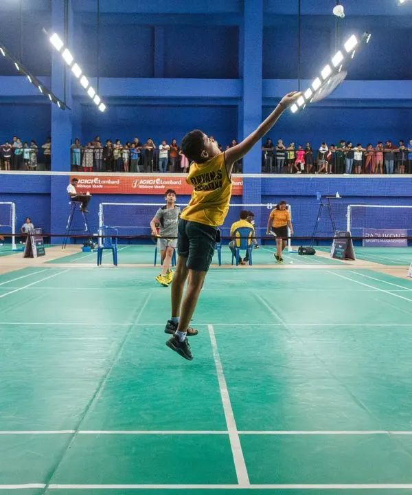 A young athlete executes a powerful jump smash during one of our professionally managed tournaments. We create an environment where players can perform at their peak, complete with professional courts, lighting, and officiating.