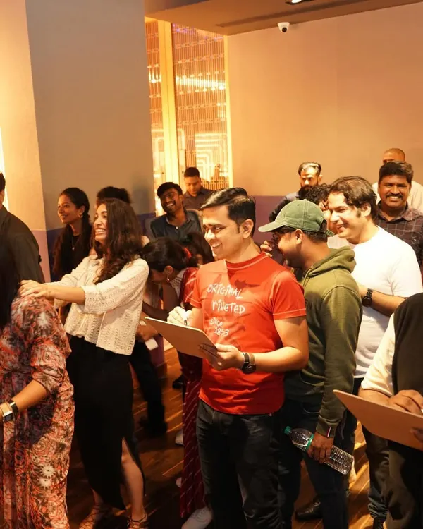 The joy and chaos of our Christmas party games! A group of attendees laughing and participating in a fun activity led by our game master.