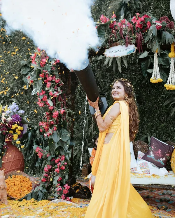 Starting the Haldi with a bang! Our bride makes a fun-filled entrance with a confetti cannon, setting a playful and celebratory tone for the day.