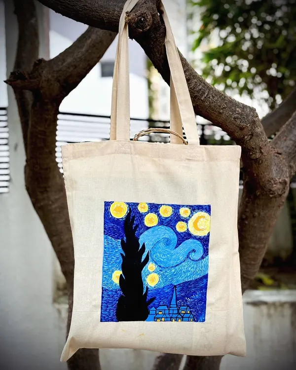 A beautiful tote bag featuring Van Gogh's "Starry Night," hand-painted by a participant in our studio. Now she can carry her masterpiece everywhere.