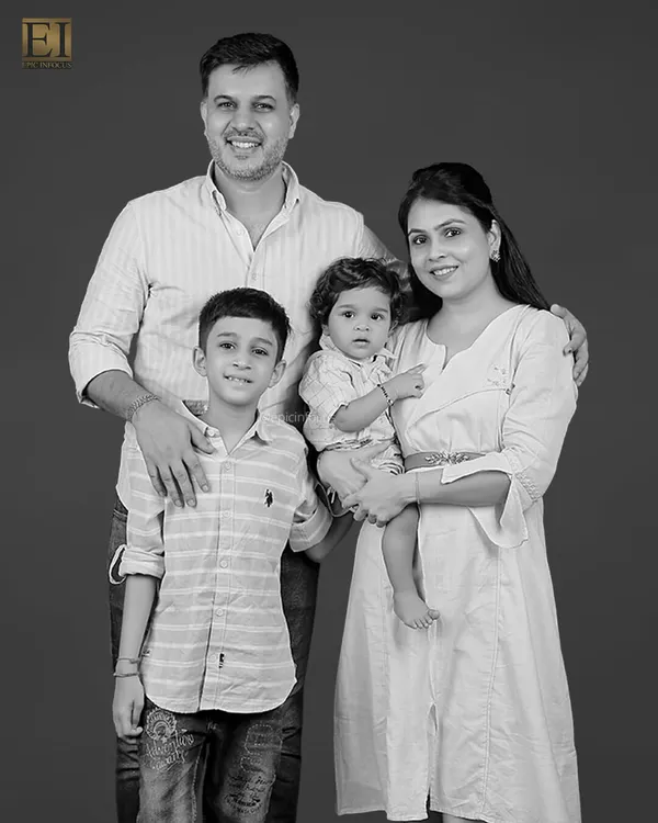 A classic black and white portrait of a beautiful family of four. These timeless photos are treasured for generations, capturing your family's unique bond.