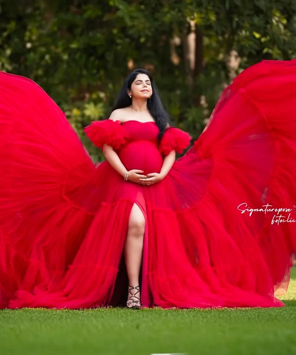 I believe every mother deserves a moment to feel like a force of nature. This outdoor session, with a vibrant red gown flowing like wings, is all about capturing that powerful, breathtaking beauty in a stunning natural setting.