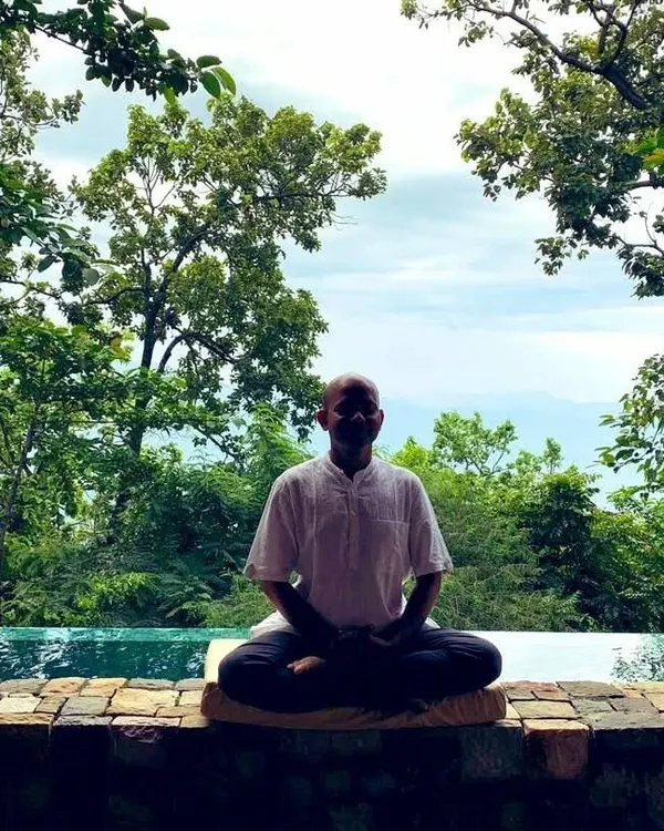 Here I am in the Himalayas, a place of immense peace. I find that meditating in nature, by the water, helps connect me to the stillness within. In my classes, I guide you to find this same sense of inner quiet, no matter where you are.